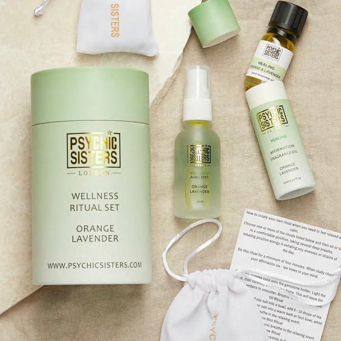 Psychic Sisters Wellness Ritual Set featuring orange and lavender aromatherapy products and Reiki-energised crystals.